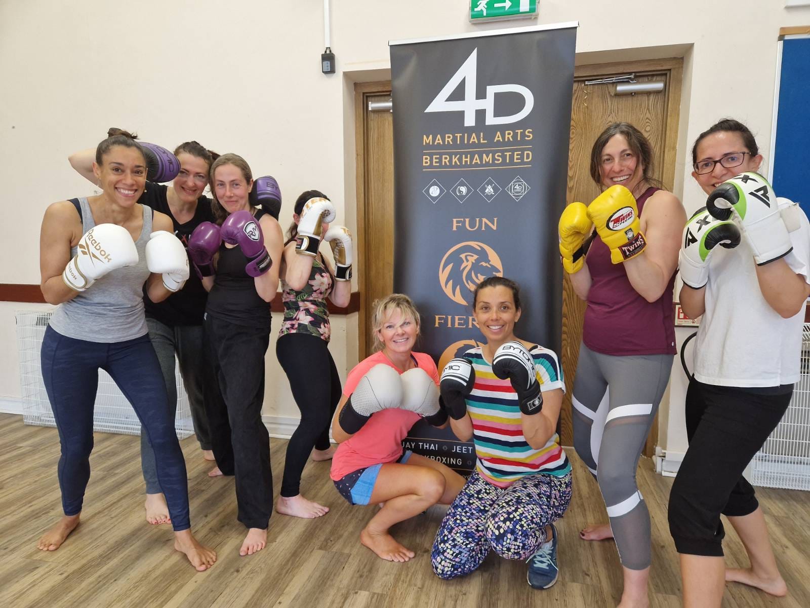 women smile after a kickboxing training session